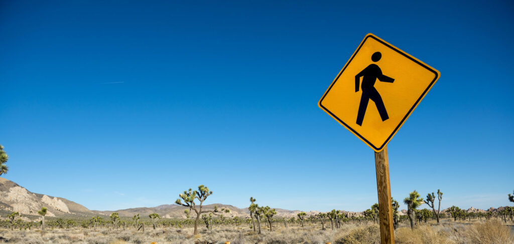 landscape of Joshua Tree with a pedestrian walking sign