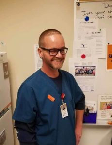 Jeff Tabor smiling in scrubs.