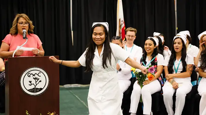 nursing student graduate doing a dance as her name is called