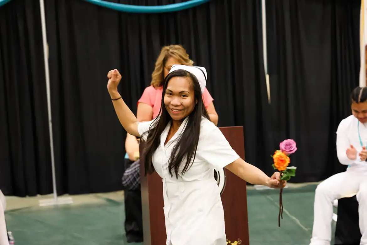 nursing student graduate doing a dance as her name is called