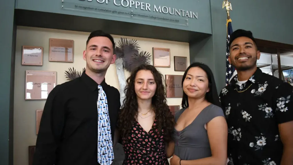 Reuben, Mariam, Julie, Roberto taking a photo in the Greenleaf library