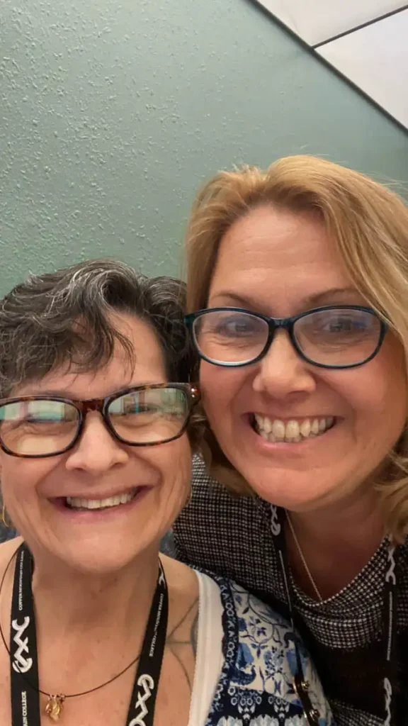 two female faculty members taking a selfie together