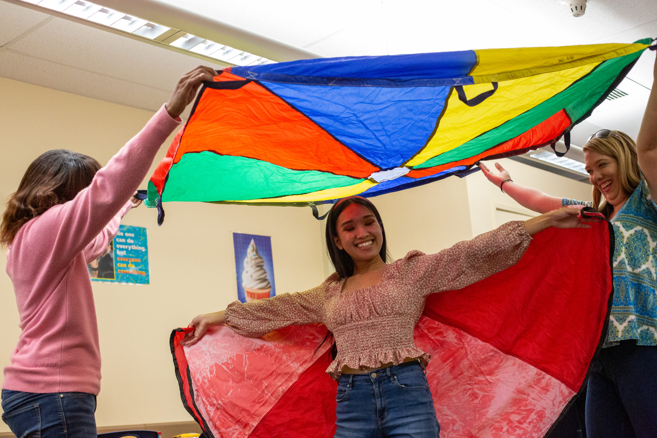 ECE student standing under colorful parachute