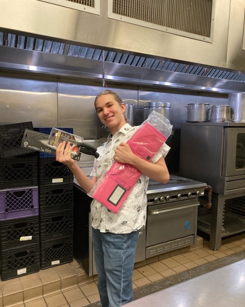 CMC Culinary Arts student receiving knife roll from CMC Foundation