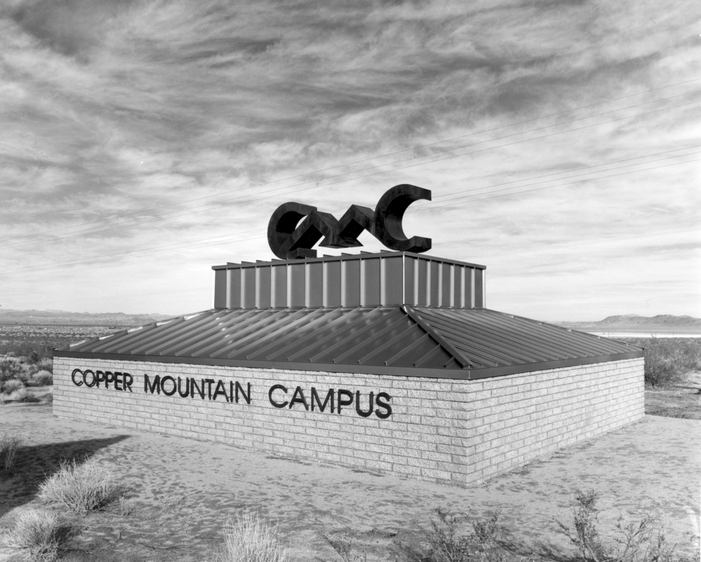 Historic black and white photo of CMC's highway sign.