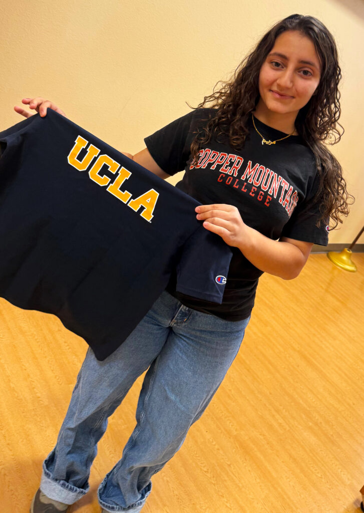 Photo of CMC Student Trustee and Greenleaf Scholar Mariam Hussain holding her UCLA shirt as she prepares to transfer to UCLA.