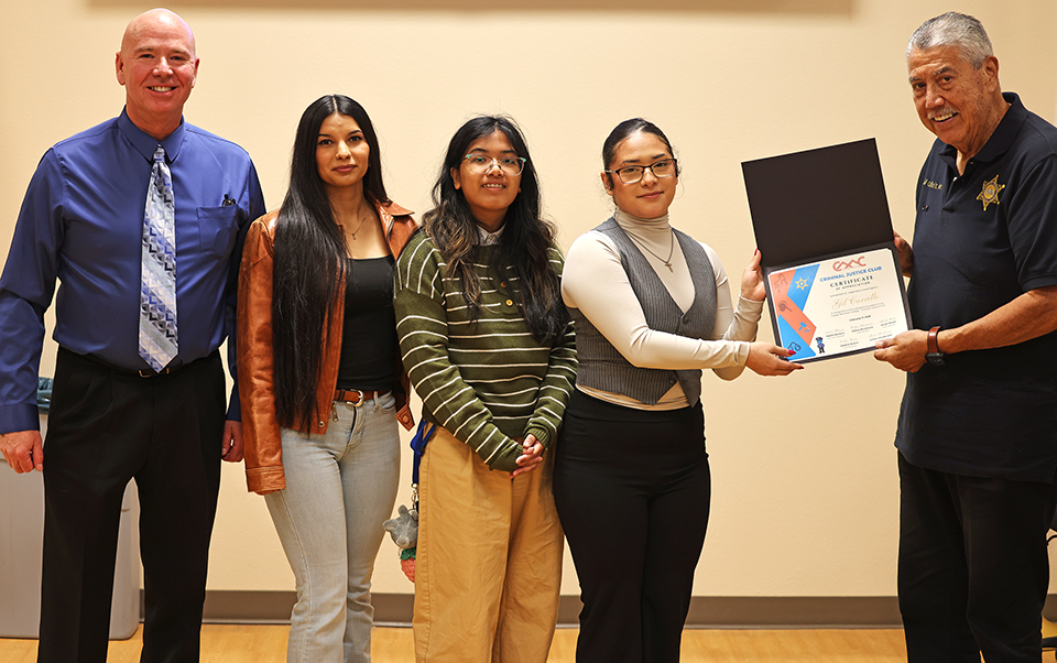 CMC's Criminal Justice Club presents Lieutenant Gil Carillo with a certificate of appreciation